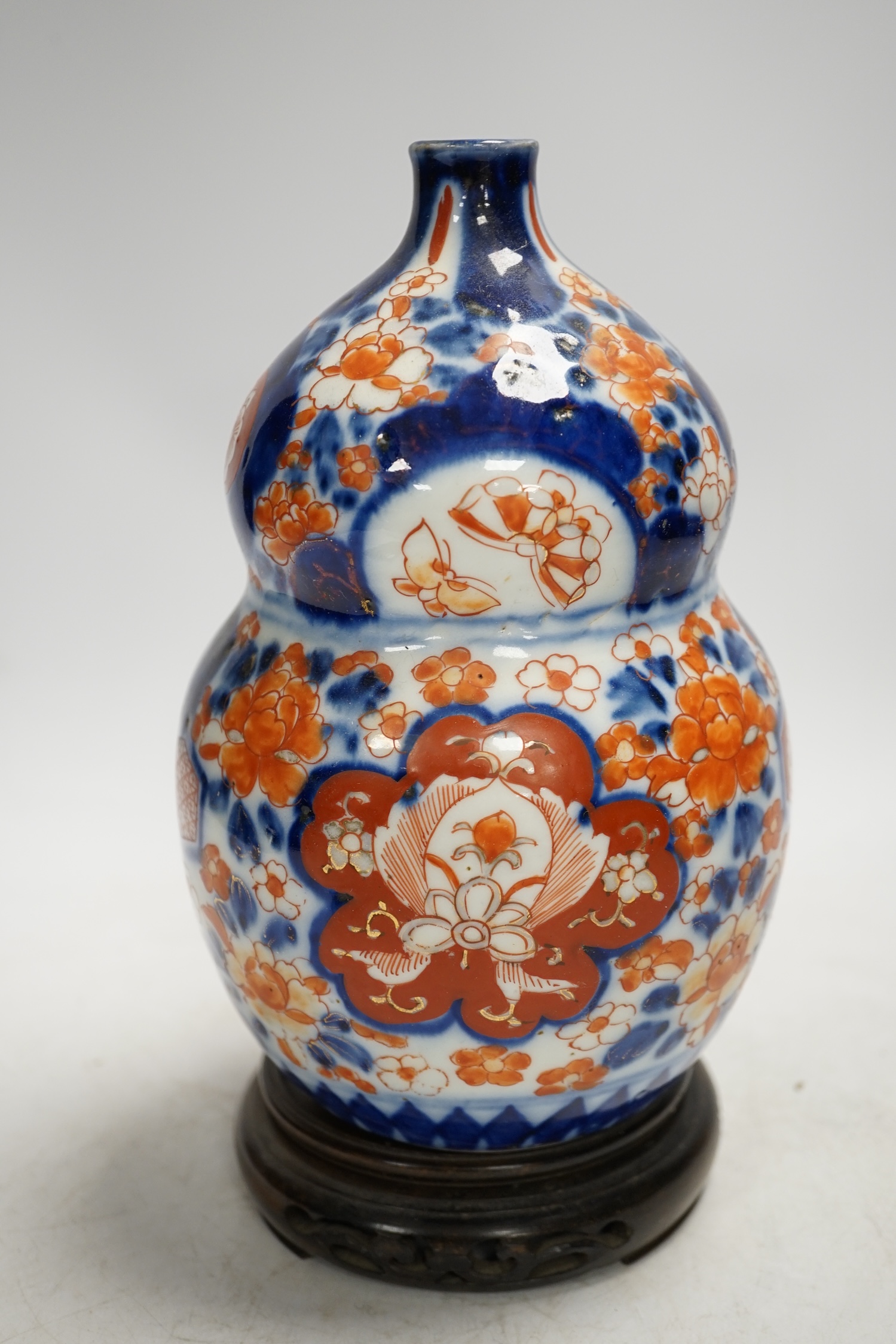 A Japanese Imari double gourd flask on stand, 23cm high. Condition - gilding worn otherwise good